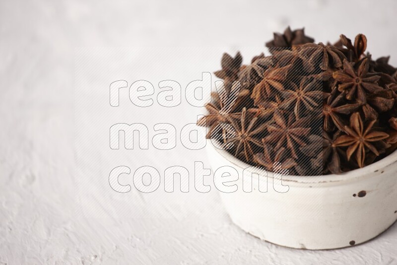 Star Anise in a white bowl on white background