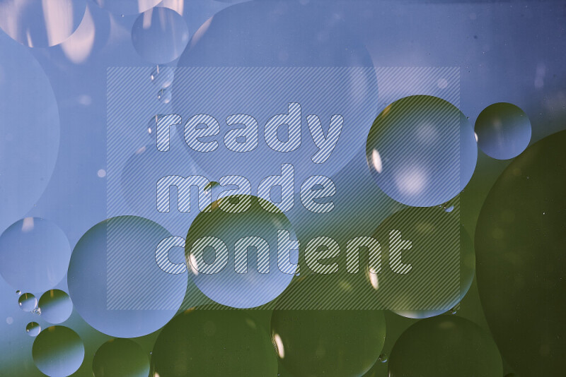 Close-ups of abstract oil bubbles on water surface in shades of blue and green