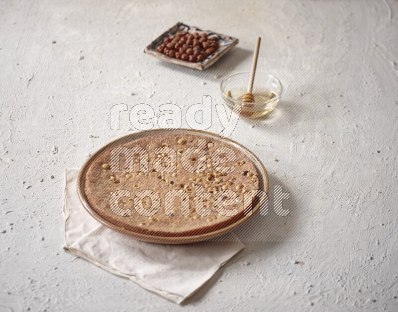 Basbousa with nuts and honey in a light setup