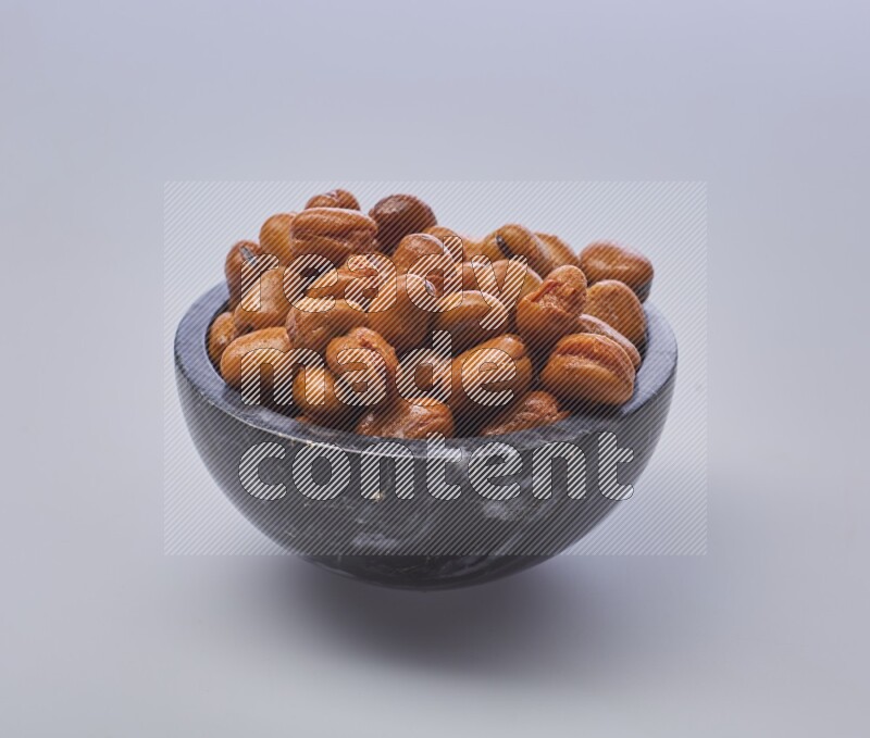 Close up shot of cooked fava beans (foul) in a container on white background