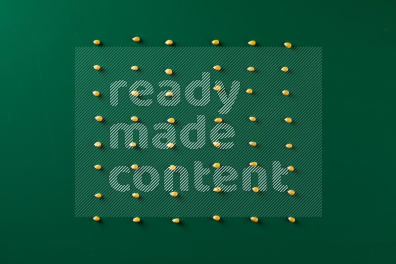 Popcorn seeds on a green background in a top view shot