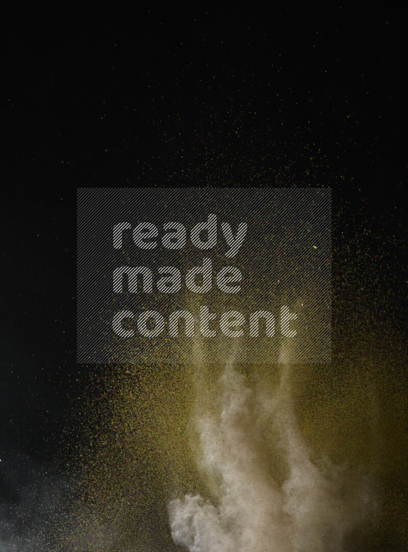 A side view of brown powder explosion on black background