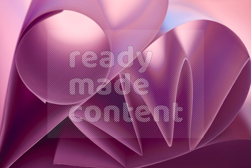 An artistic display of paper folds creating a harmonious blend of geometric shapes, highlighted by soft lighting in purple tones