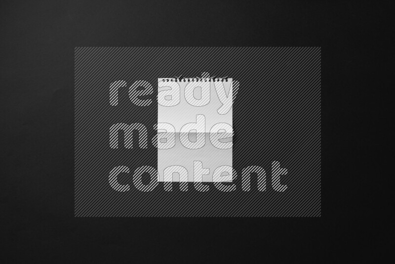Folded notebook sheet on black background