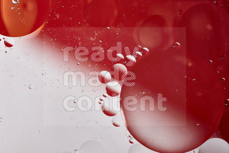 Close-ups of abstract oil bubbles on water surface in shades of white and red