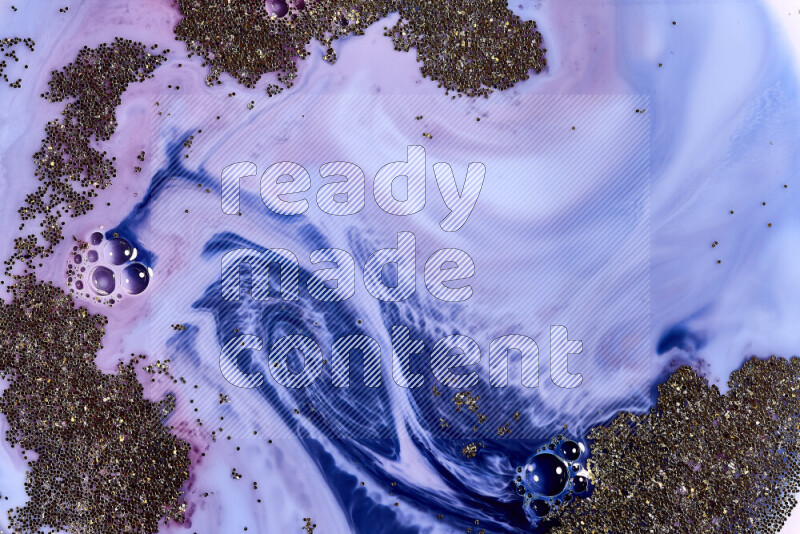 A close-up of sparkling gold glitter scattered on swirling blue and red background