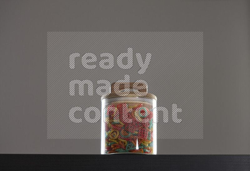 Snacks in a glass jar on black background