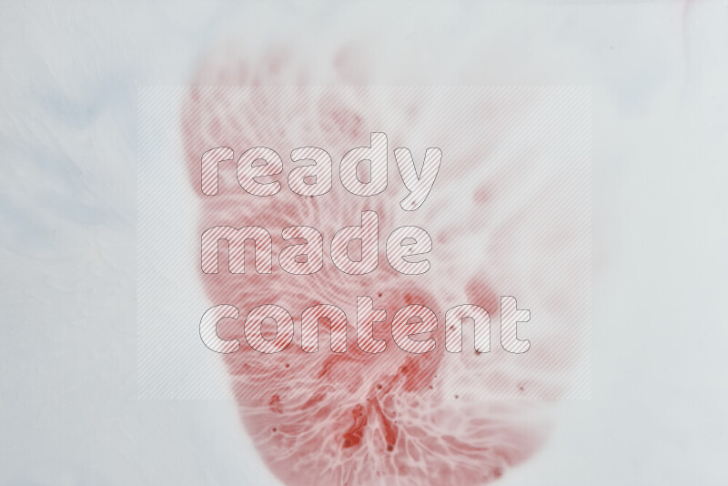 A close-up of abstract swirling patterns in red and white