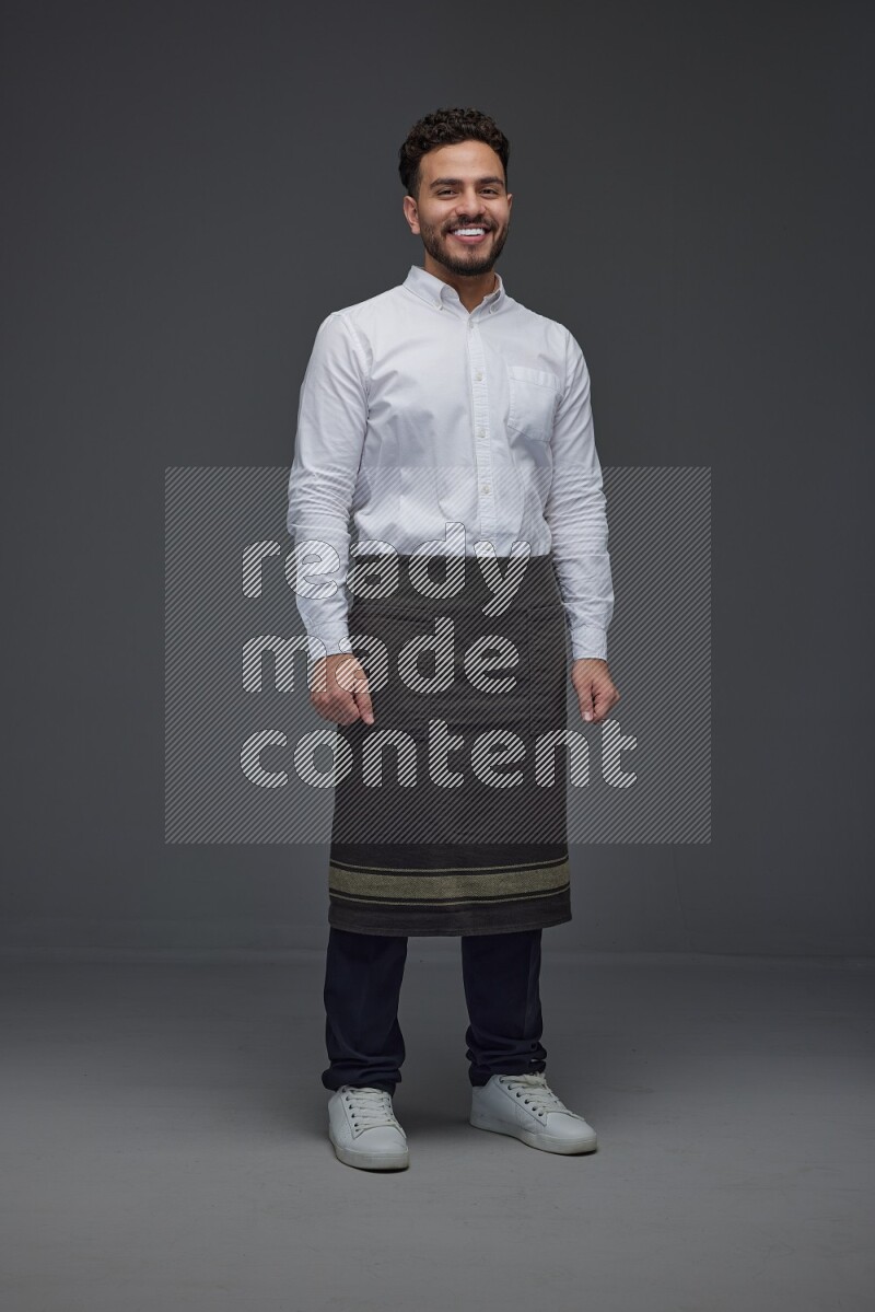A man wearing smart casual and apron standing and making multi poses eye level on a gray background