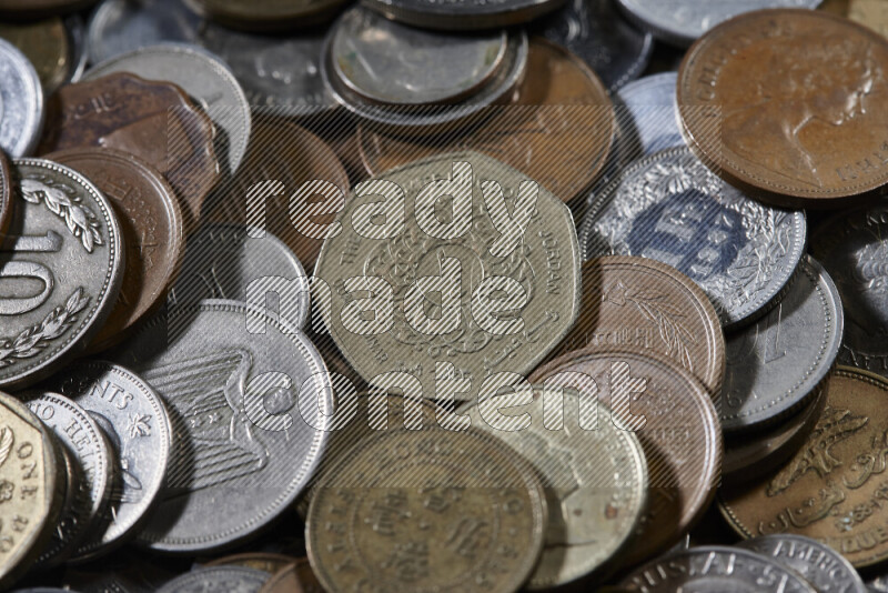 A close-ups of random old coins on black background