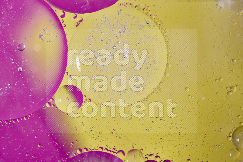 Close-ups of abstract oil bubbles on water surface in shades of yellow and pink