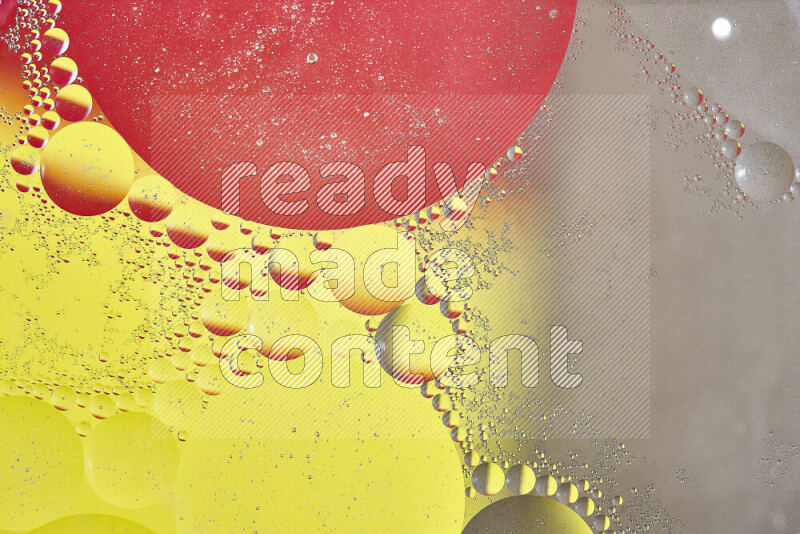 Close-ups of abstract oil bubbles on water surface in shades of yellow, red and brown