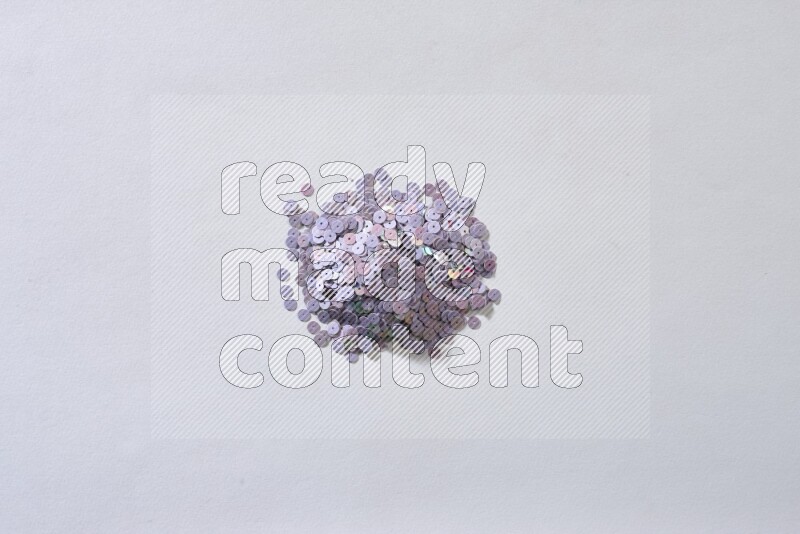 Multicolored flat sequins on grey background