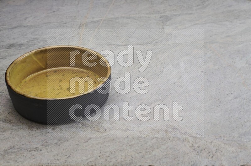 A multicolored pottery oven plate on grey marble background