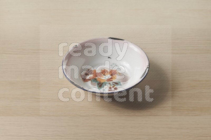 A vintage metal plate on light wooden background