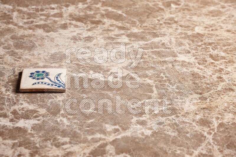 A decorative coaster on beige marble background