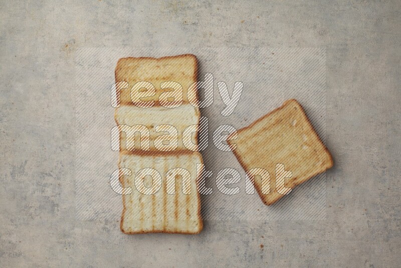 Toasted white Toast slices on a light blue textured background