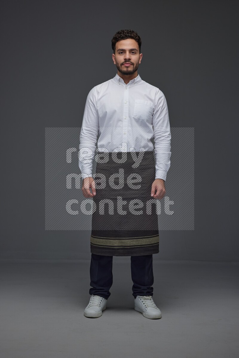 A man wearing smart casual and apron standing and making multi poses eye level on a gray background
