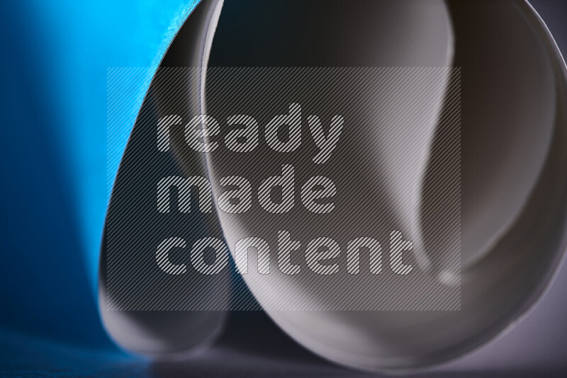 An abstract art piece displaying smooth curves in blue and white gradients created by colored light