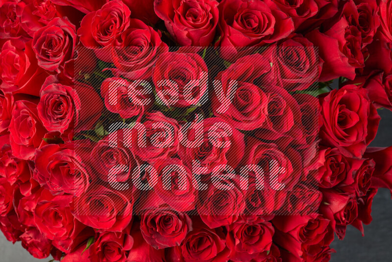 A luxurious bouquet of red roses on black marble background