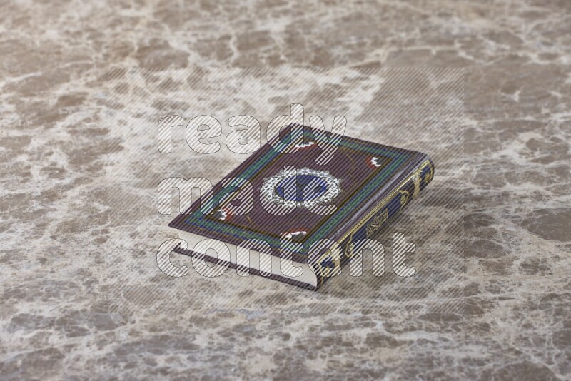 The holy Quran on beige marble background
