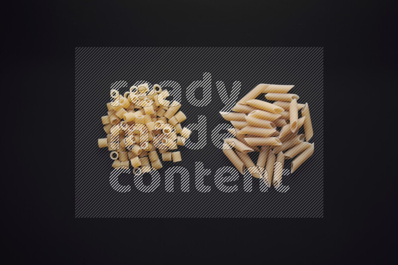Different pasta types in bunches on black background