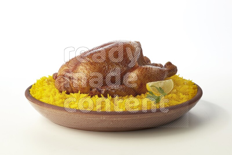 yellow basmati Rice with whole roasted chicken  on a pottery plate  direct  on white background