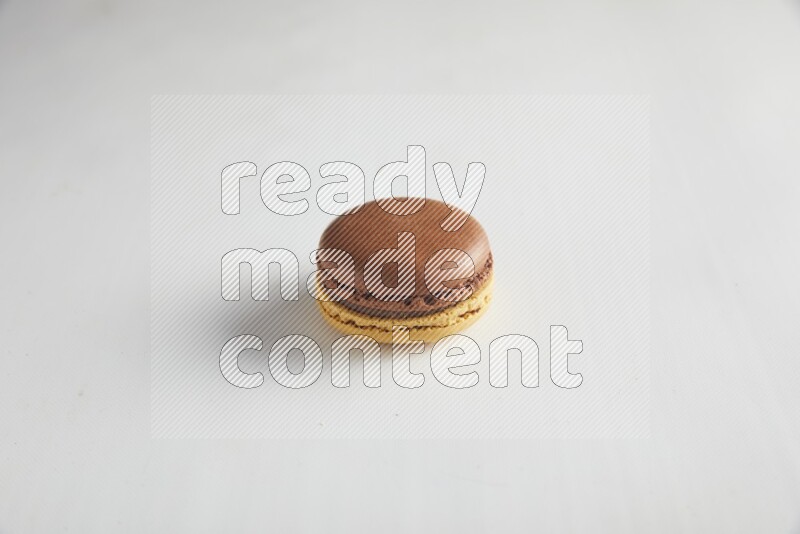 45º Shot of Yellow and Brown Chai Latte macaron on white background