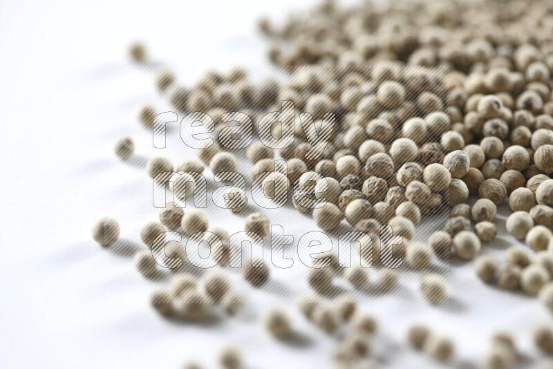 White pepper beads on white background