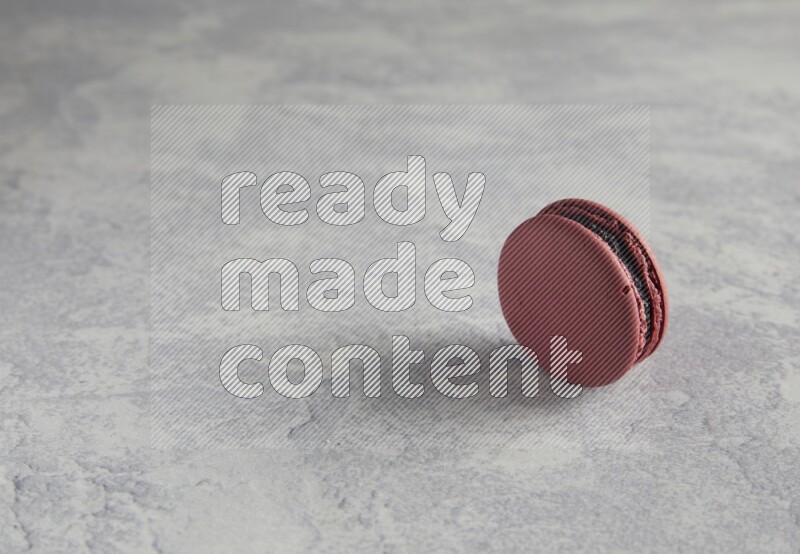 45º Shot of Red Cherry macaron on white  marble background
