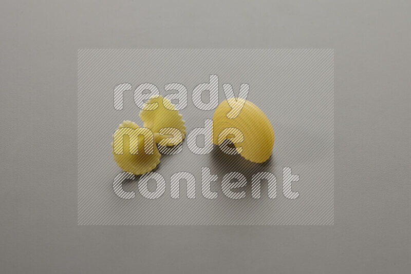 Fiocchi pasta with other types of pasta on grey background