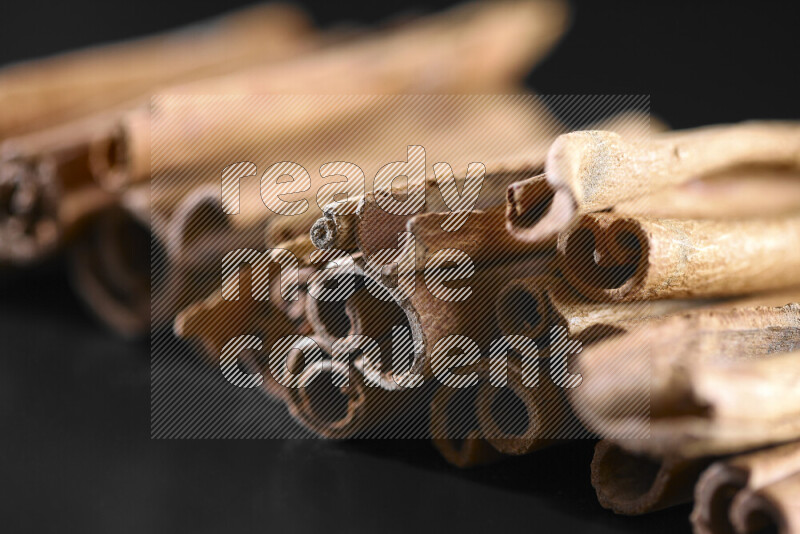 Cinnamon sticks on black background