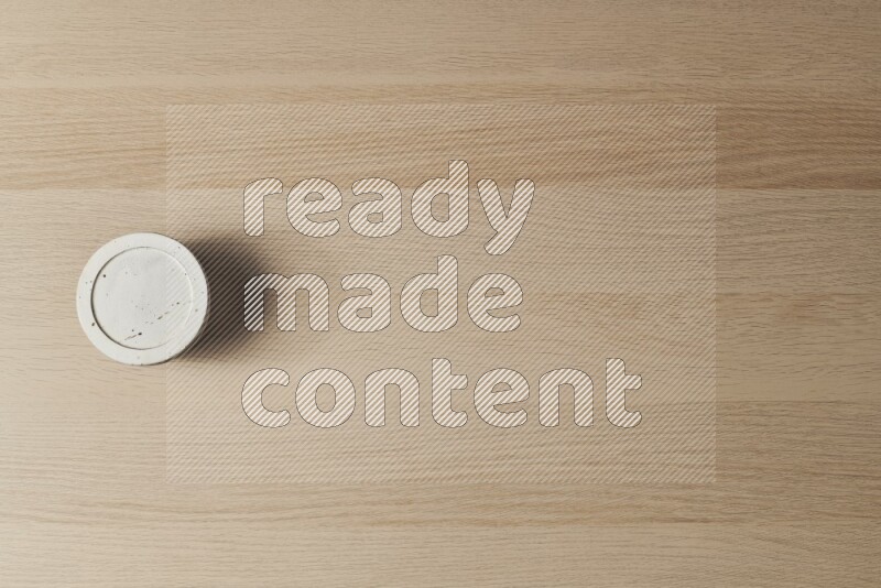 A white pottery bowl on light wooden background