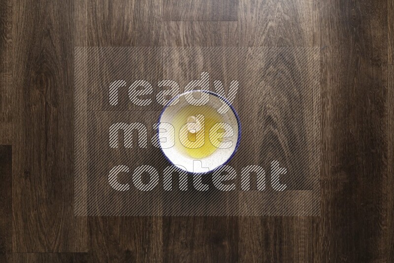 A bowl full of spices and salad dressing ingredients on wooden background