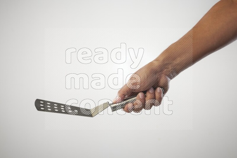 Male Hand Holding Burger Flipper on white background