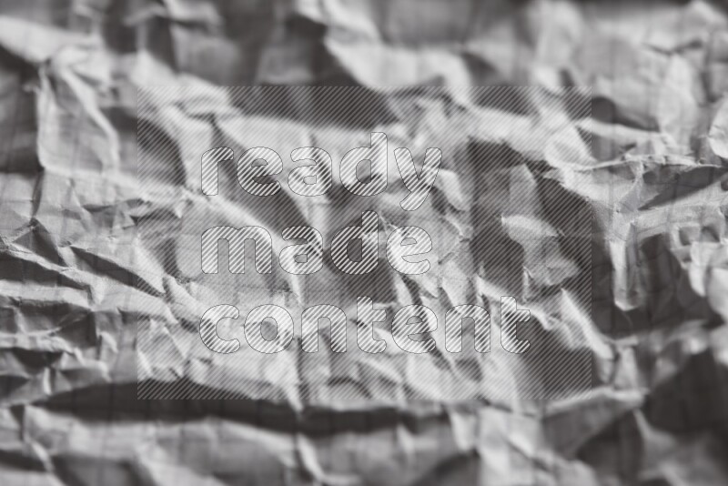 Crumpled notebook sheet on black background
