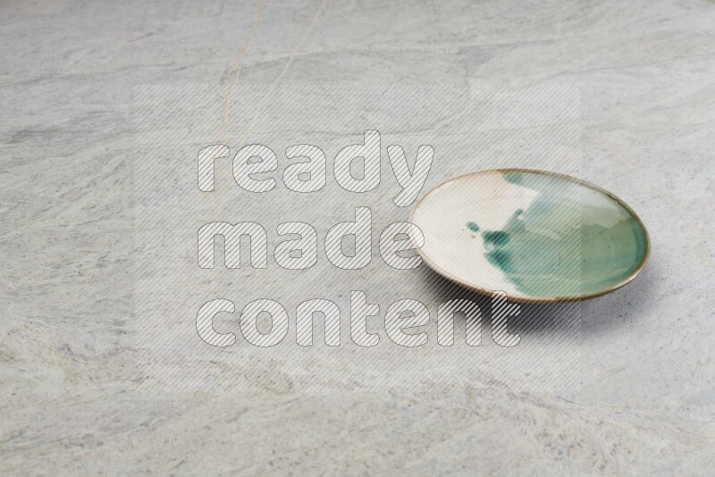 Multicolored Pottery Plate On Grey Marble Flooring