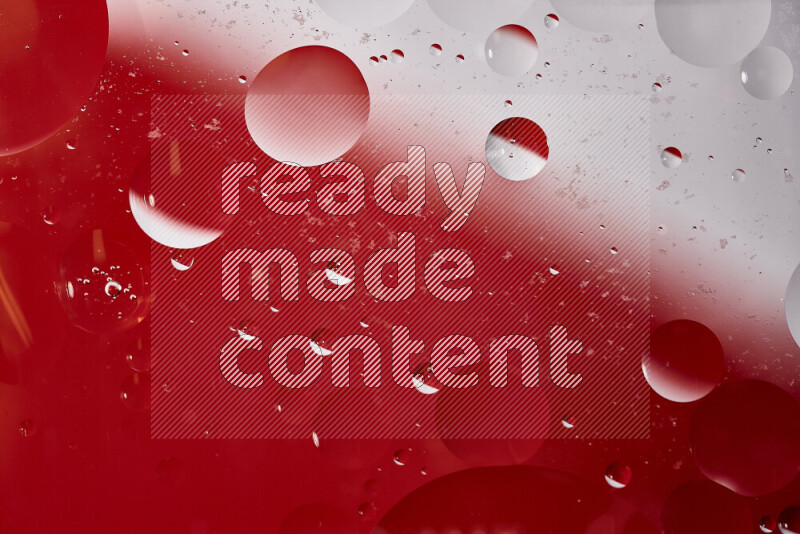 Close-ups of abstract oil bubbles on water surface in shades of white and red