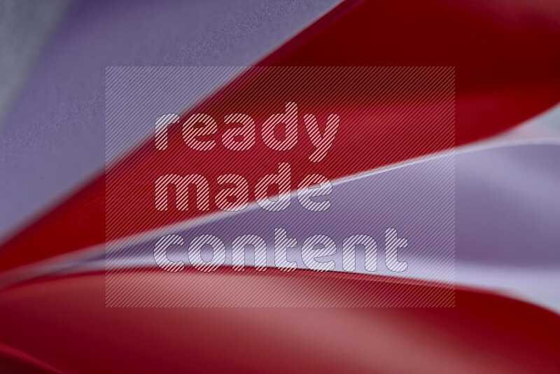 An abstract art showing purple and red paper sheets arranged in an overlapping curves