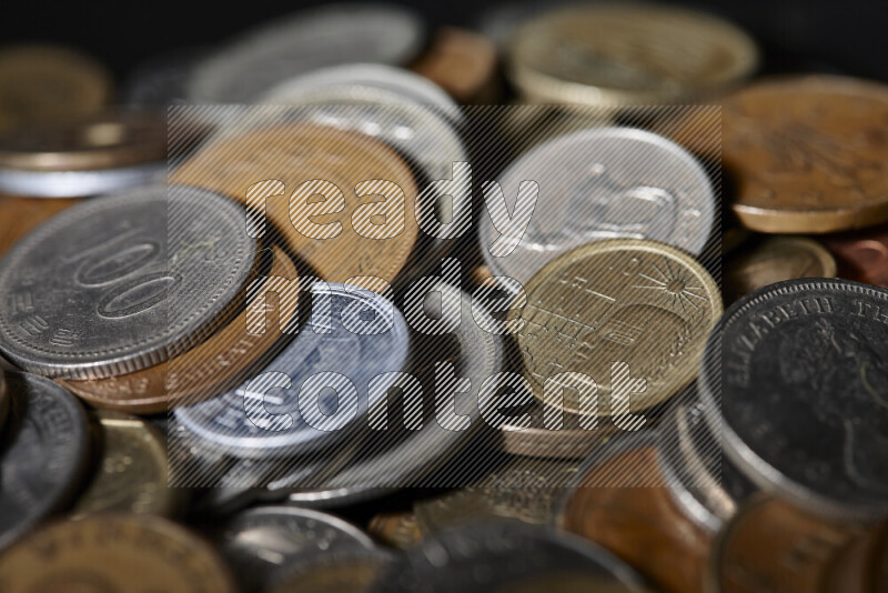 A close-ups of random old coins on black background