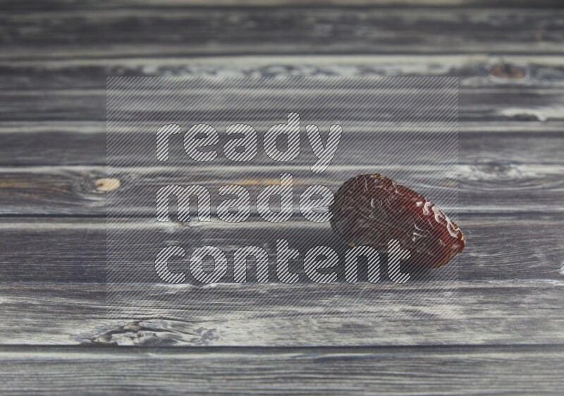 one madjoul date on a wooden grey background