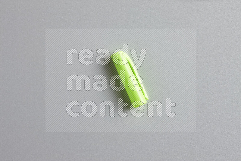 A close-up showing a single colored pen cap on grey background