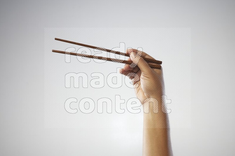 Male Hand Holding Chop Stick on white background