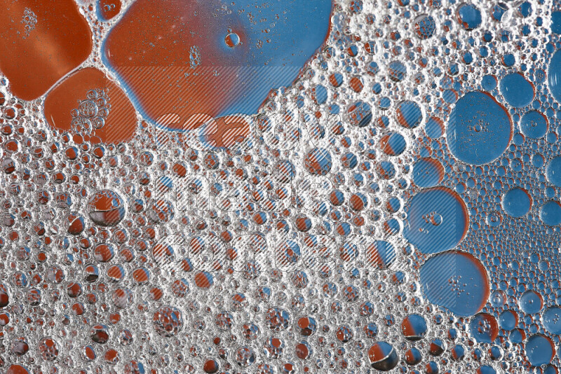 Close-ups of abstract soap bubbles and water droplets on orange and blue background