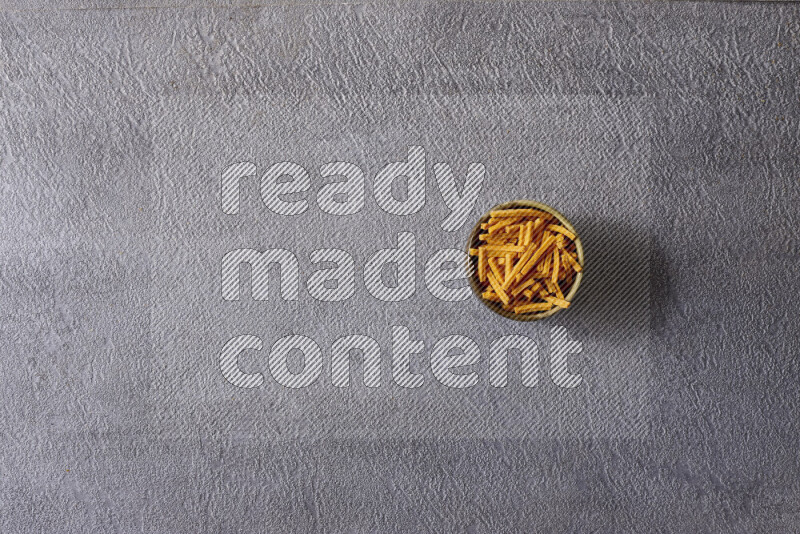 Assorted snacks in pottery bowls on grey background