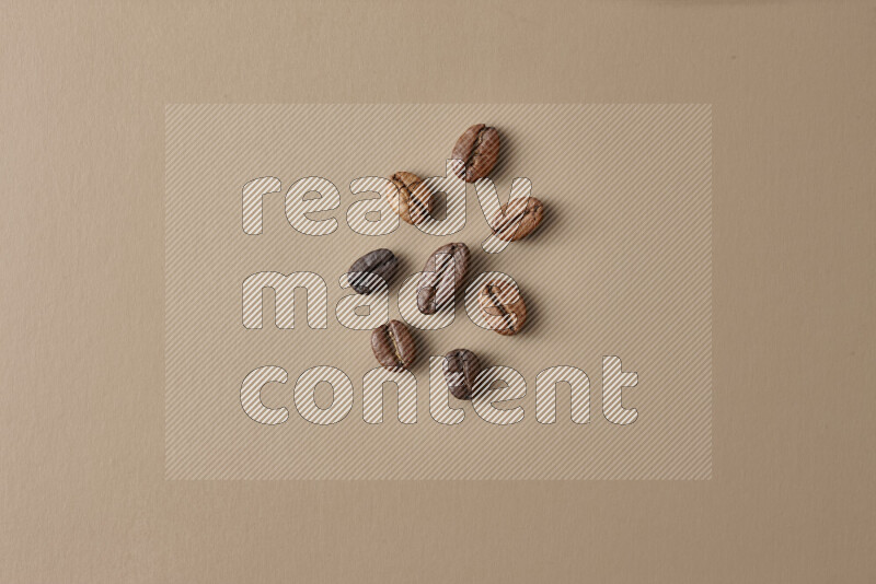 Roasted coffee beans on beige background