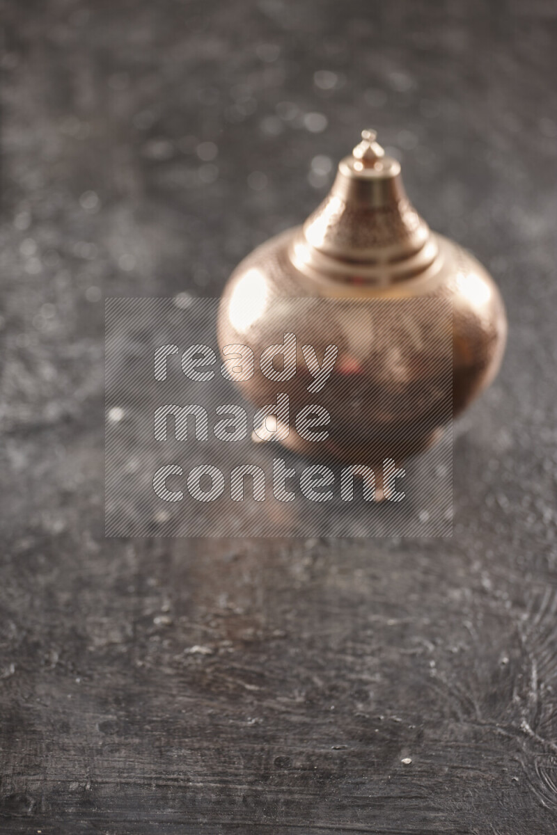 A lantern placed on a textured black background