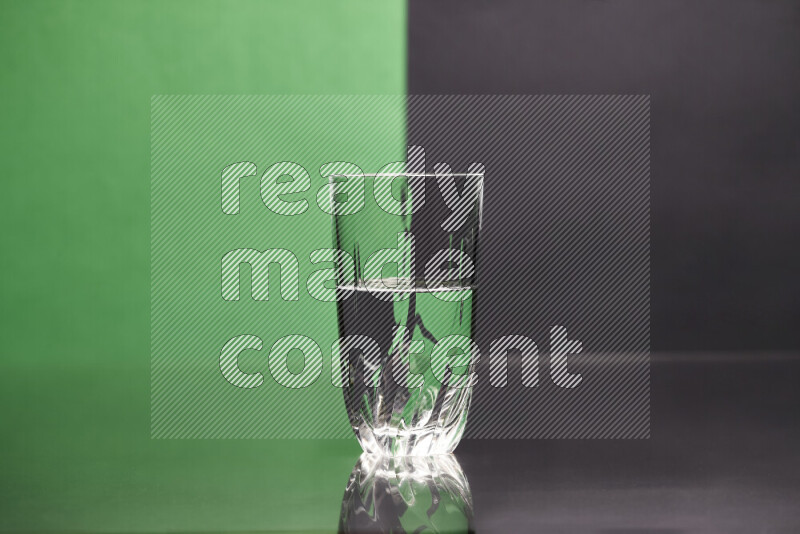 The image features a clear glassware filled with water, set against green and black background