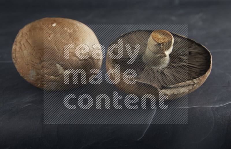 45 degre portobello mushrooms on a textured black slate background