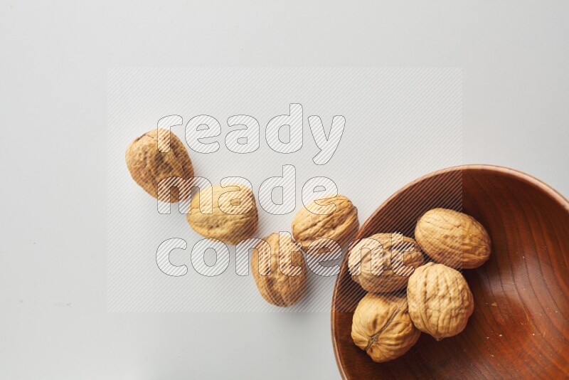 Top-view shot of walnut in a container on white background